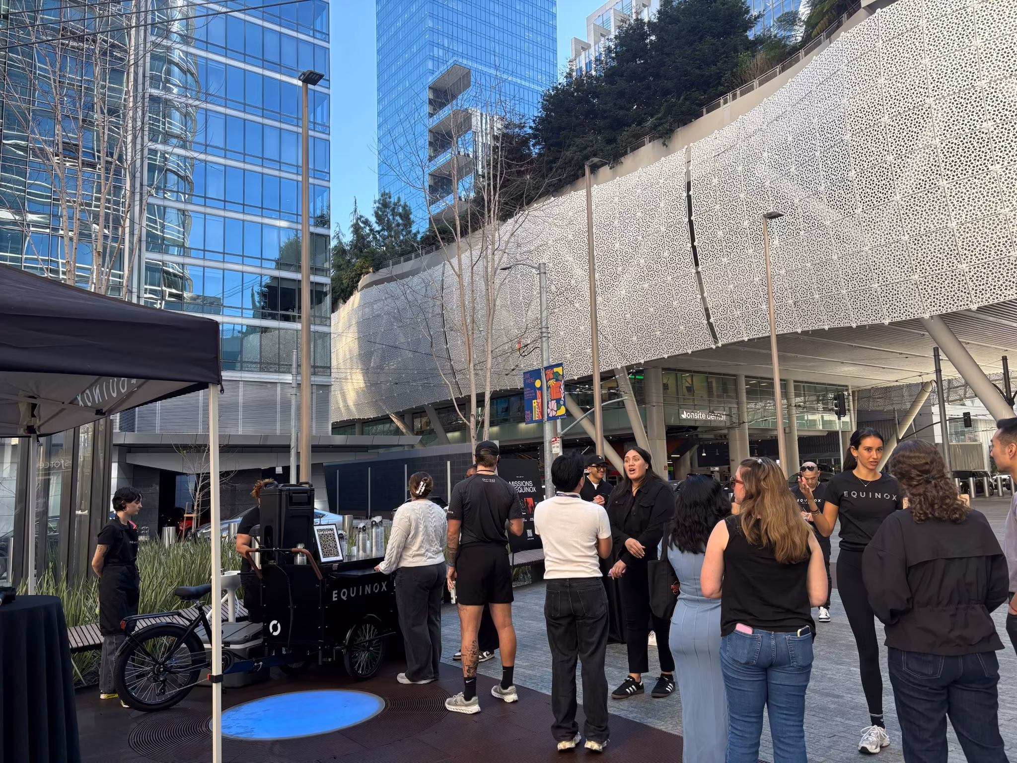Crowd gathered outside a branded coffee cart at a conference