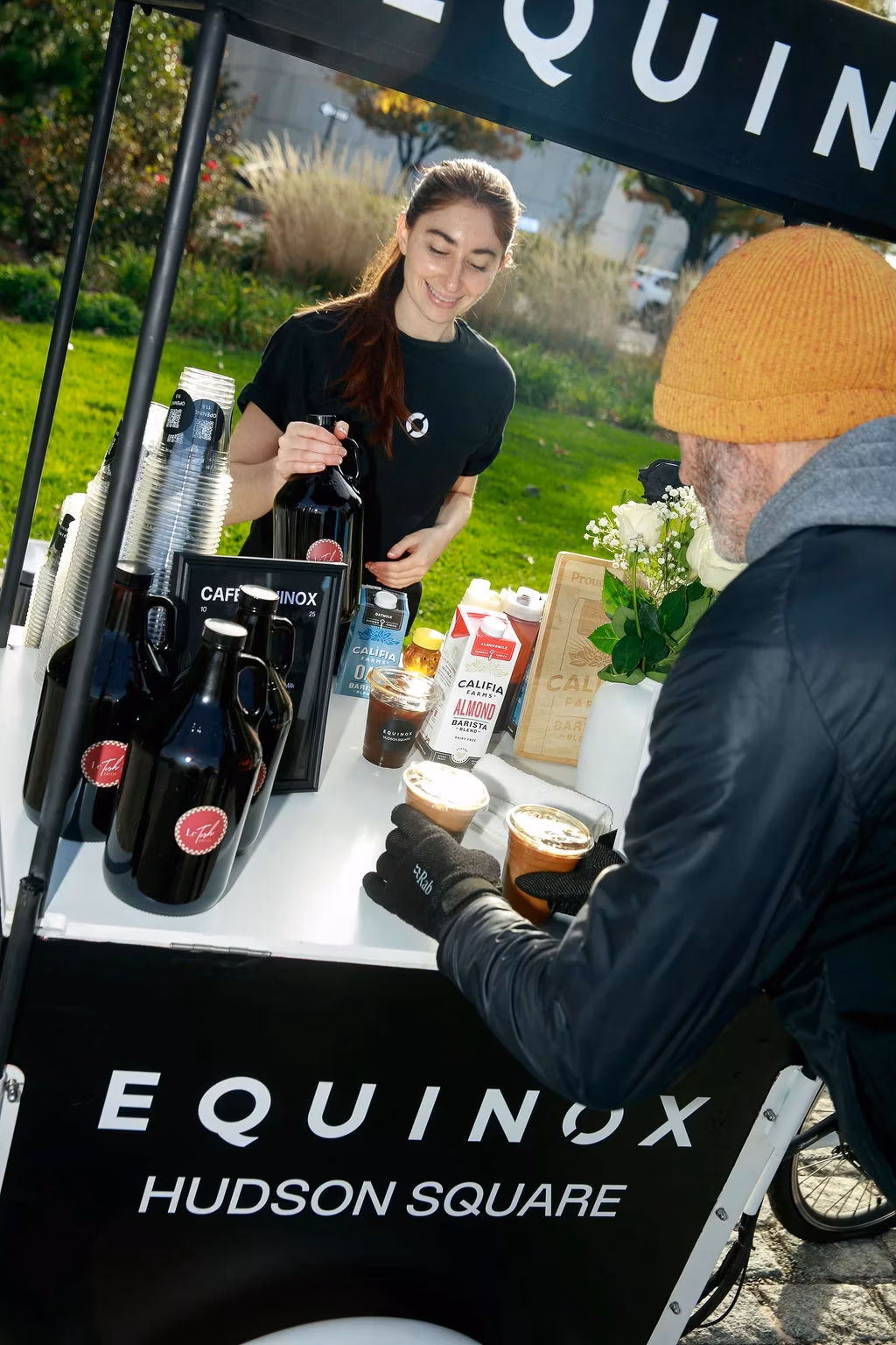 Branded coffee cart serving customers at event